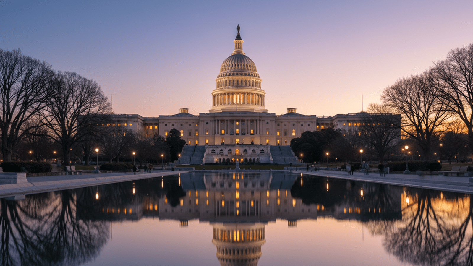 The United States Capitol building stands illuminated at dusk.