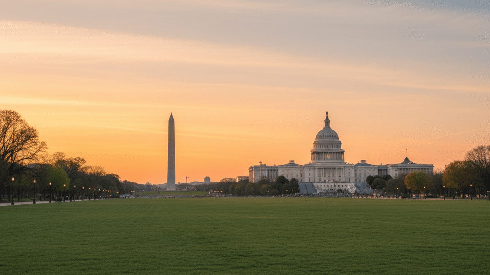 A wide view of the National Mall in Washington, D.C., under a golden sunset sky.