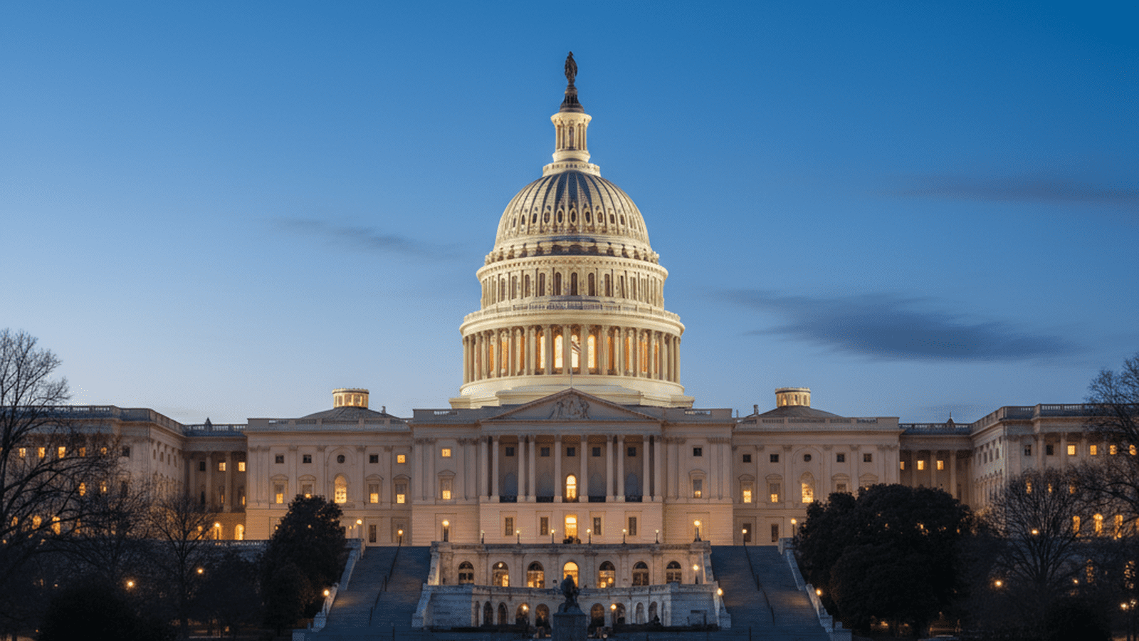 The United States Capitol building illuminated at night under a clear sky.