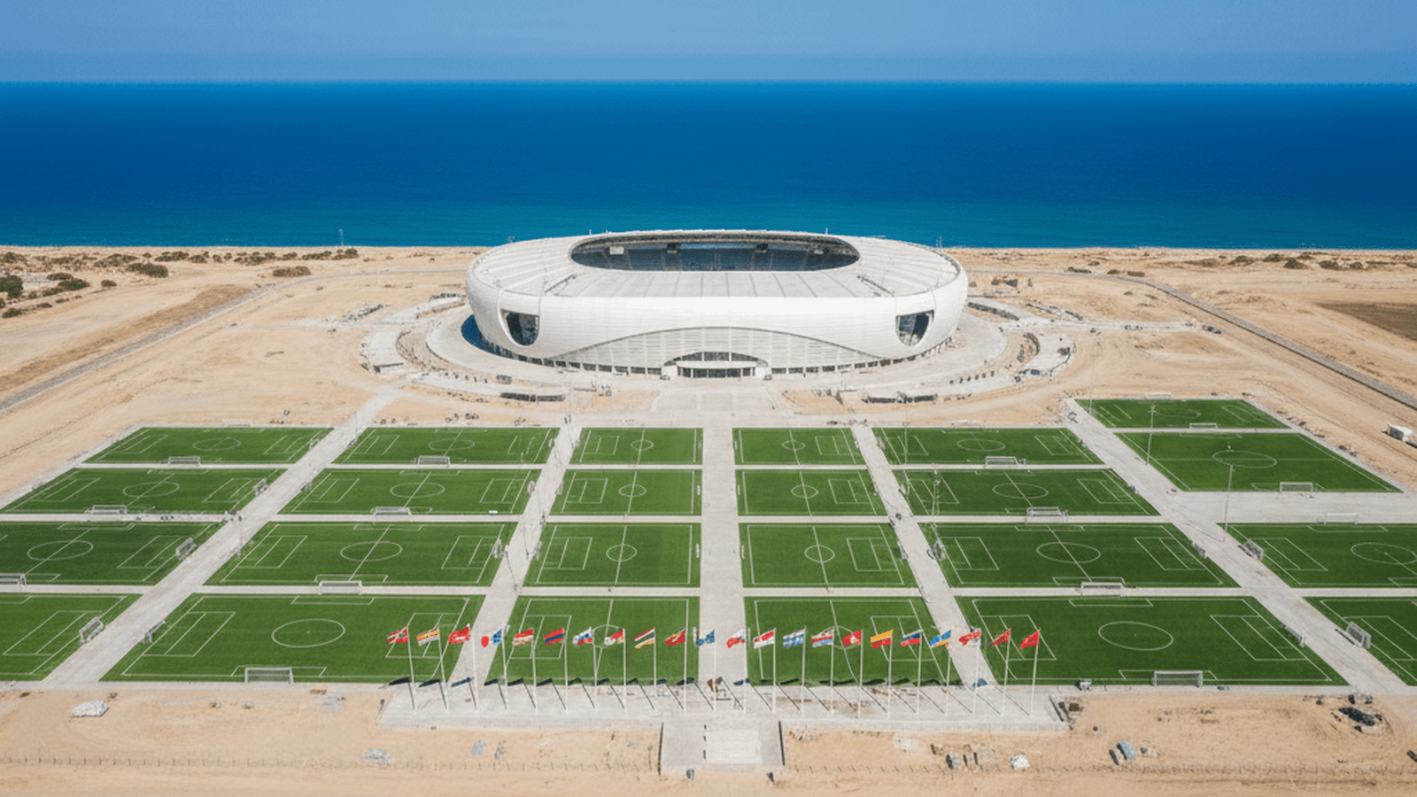 A rendering of a new national soccer stadium and multiple smaller pitches in a coastal region.