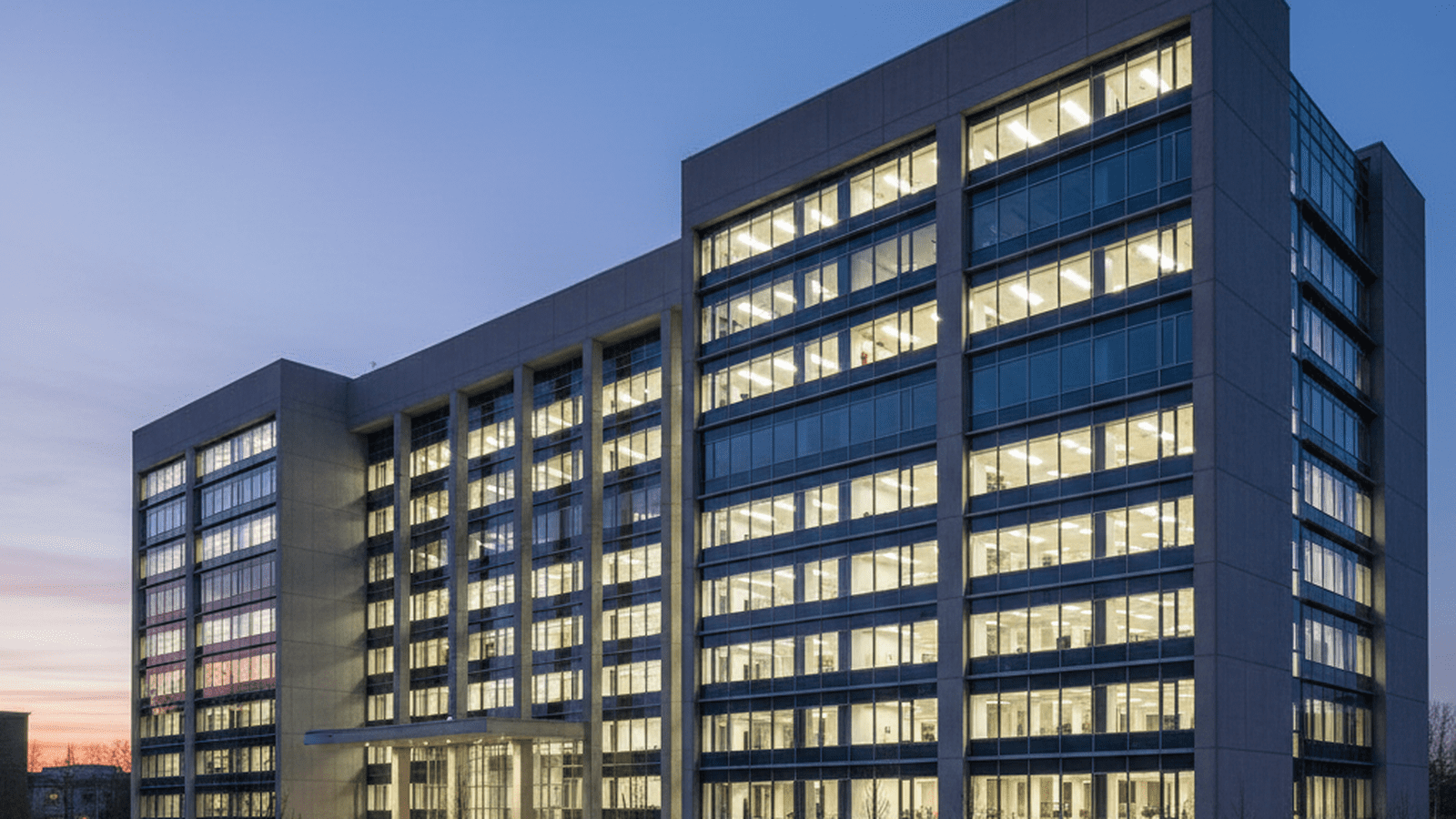 A large, clean government building stands under a darkening sky, representing institutional stability.