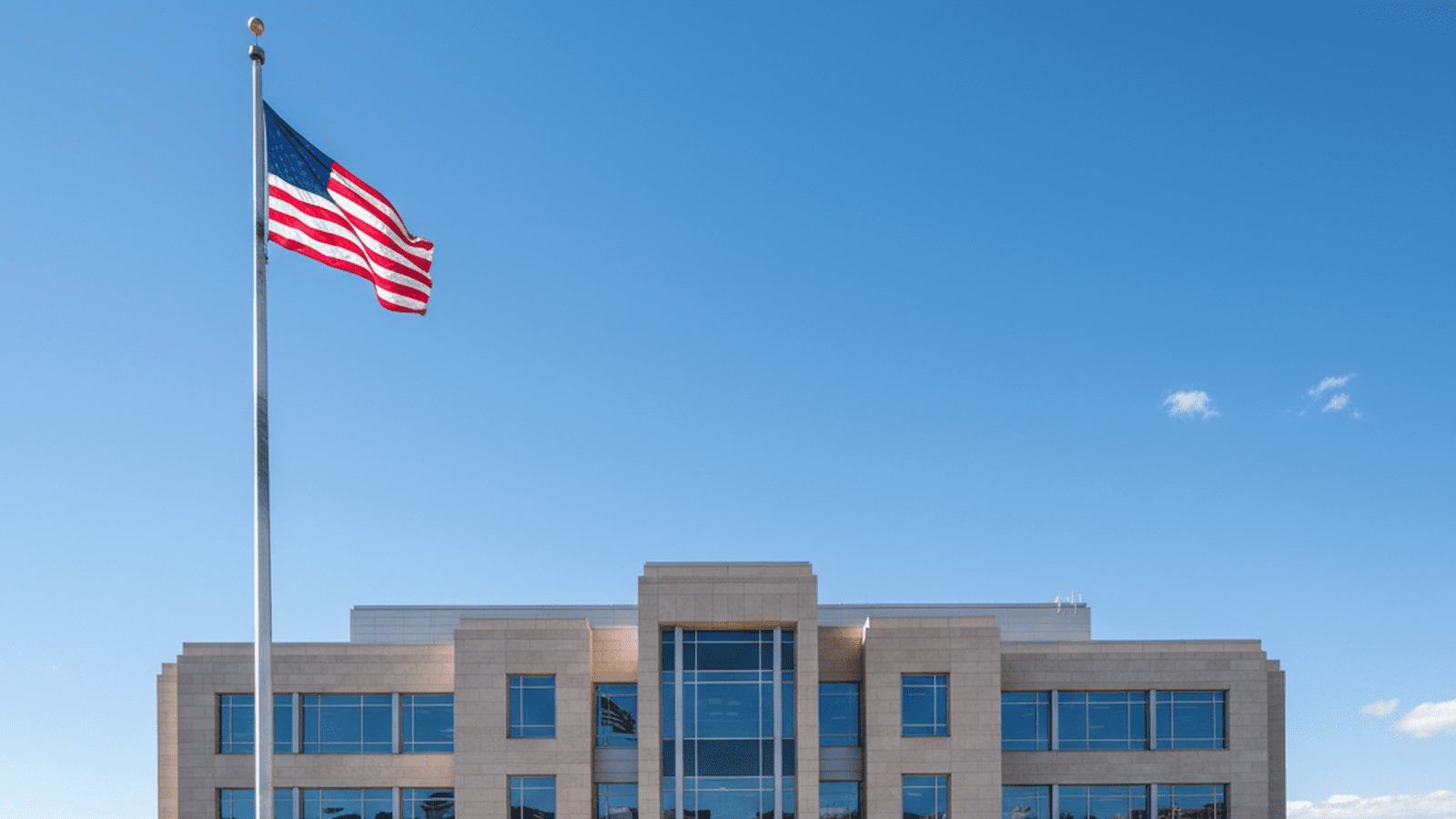 A professional and orderly government building in Colorado with the state flag flying.