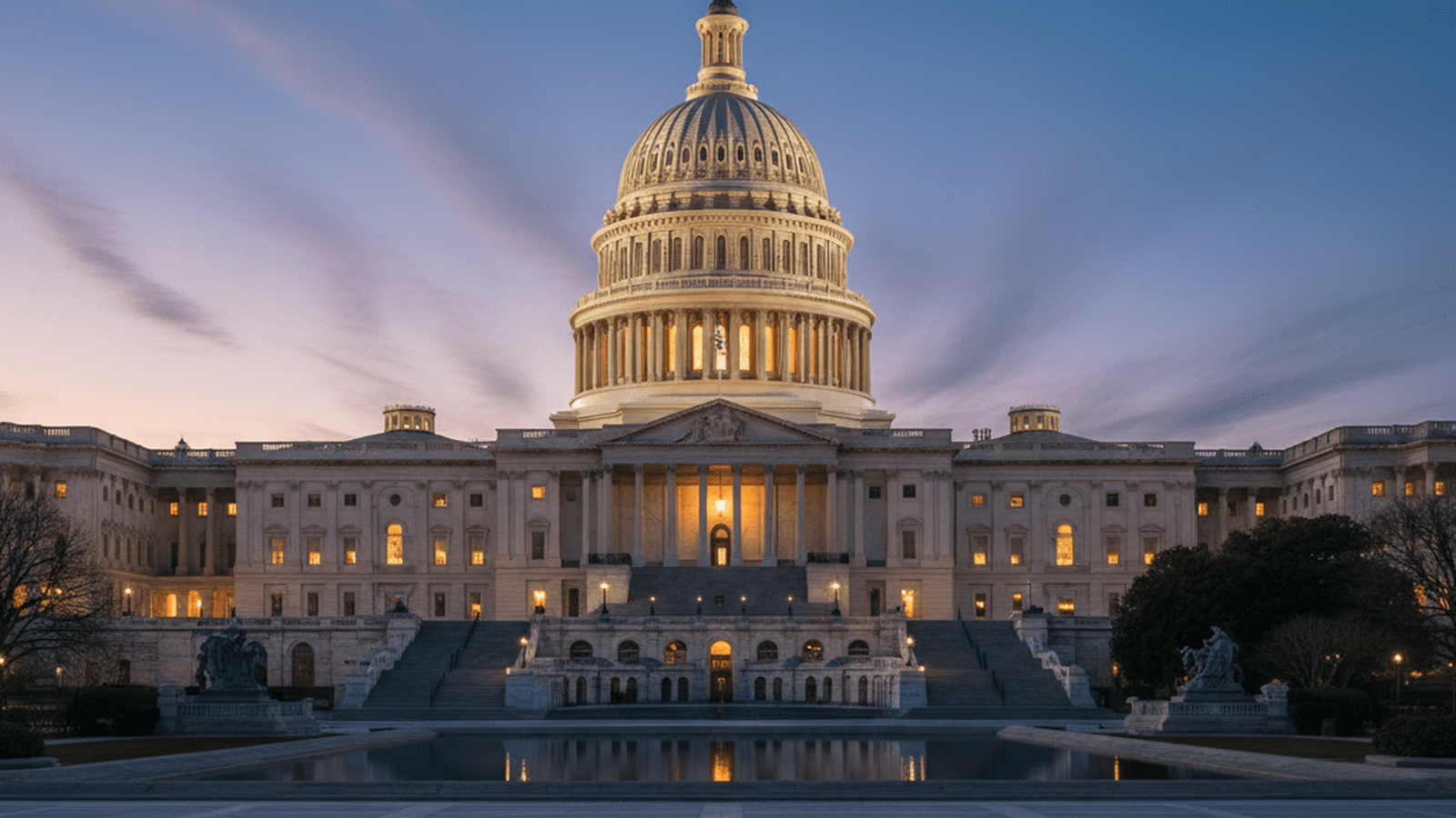 The illuminated dome of the U.S. Capitol building stands against a dark evening sky.