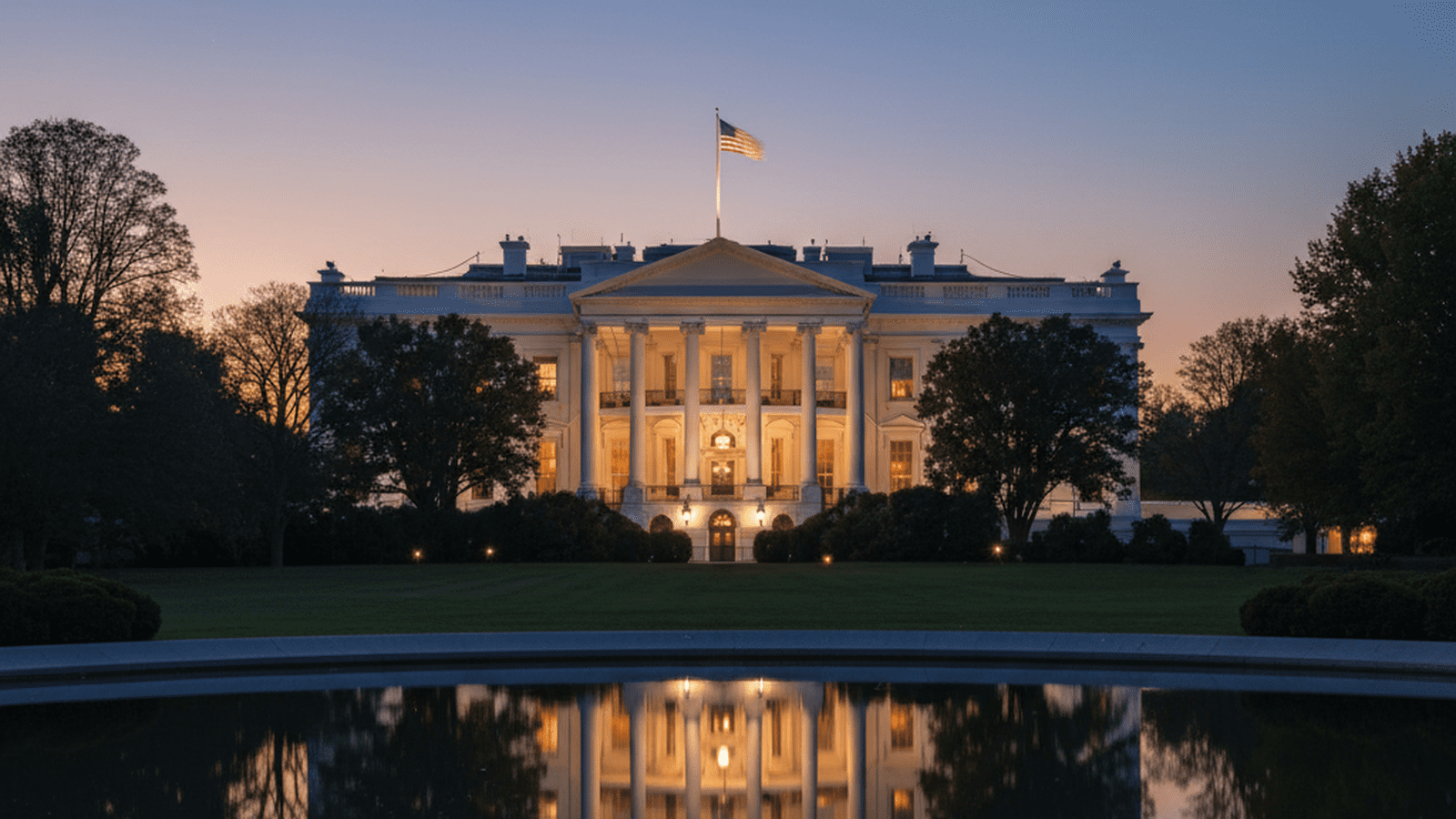 The White House stands illuminated against a darkening sky in Washington.