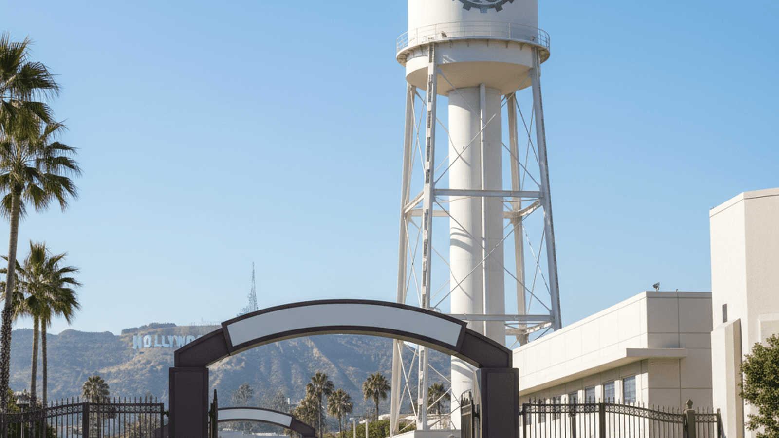 The Paramount Pictures water tower stands prominently in Los Angeles with the Hollywood sign in the distance.