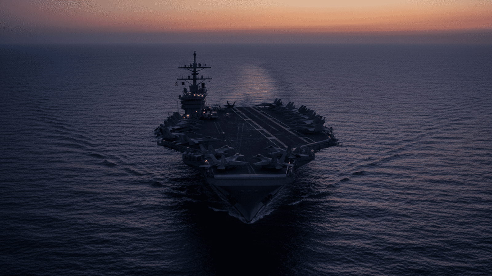 A U.S. aircraft carrier positioned in the water during a military operation.