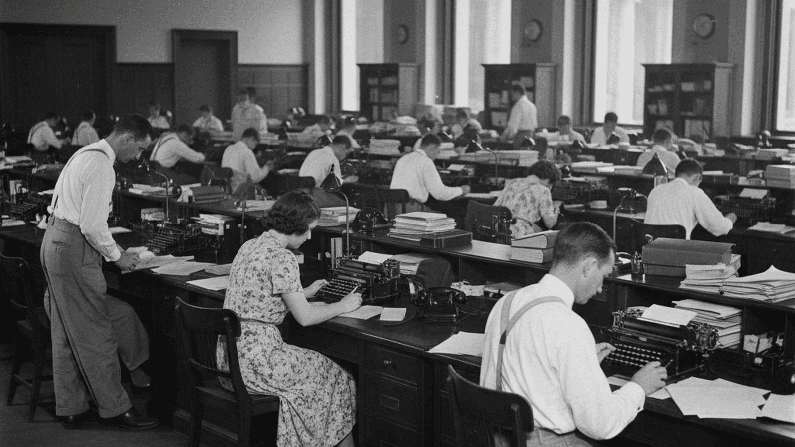 A black and white 1939 photograph of federal employees working in a Washington D.C. office during the New Deal era.