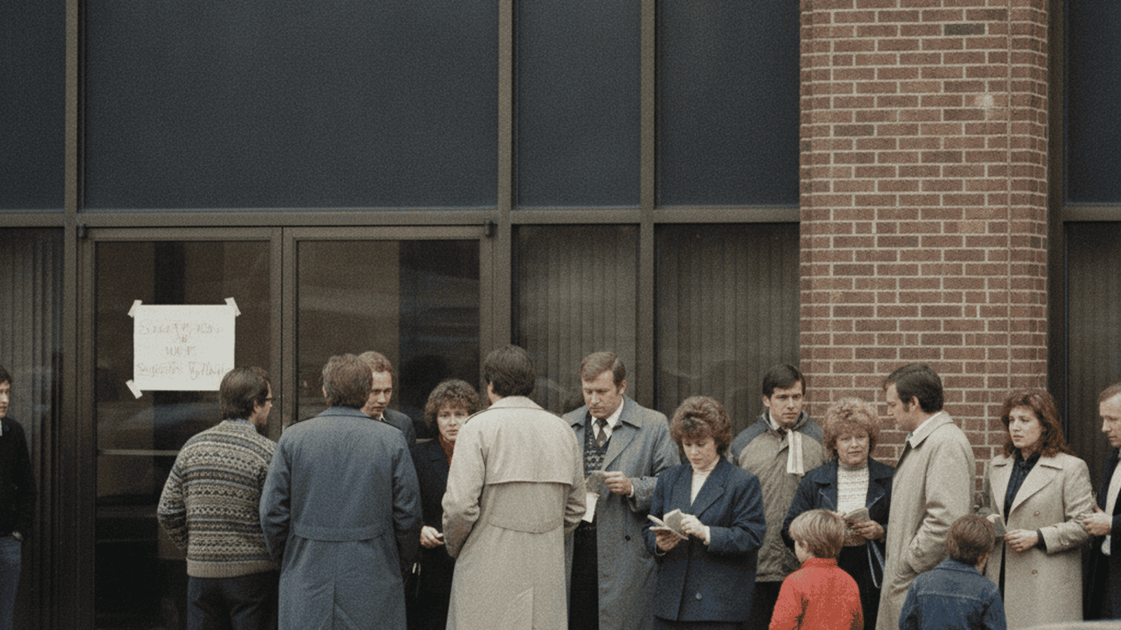 A crowd of people waits outside a closed savings and loan building in Ohio during the 1985 banking crisis.