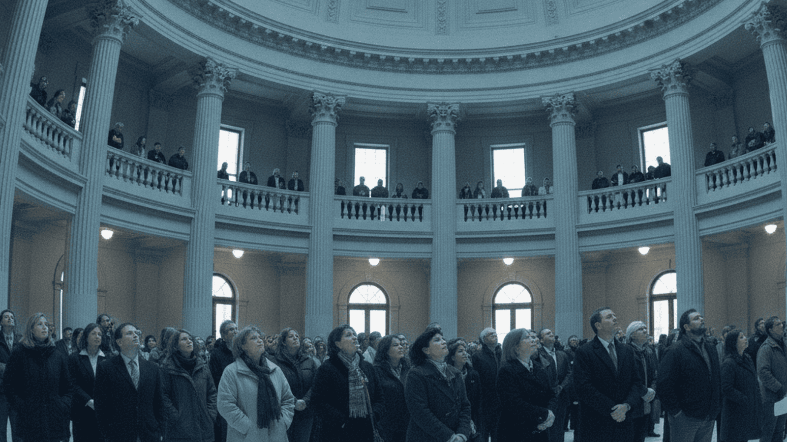 A wide shot of the South Dakota State Capitol rotunda filled with people during a 2017 legislative session.