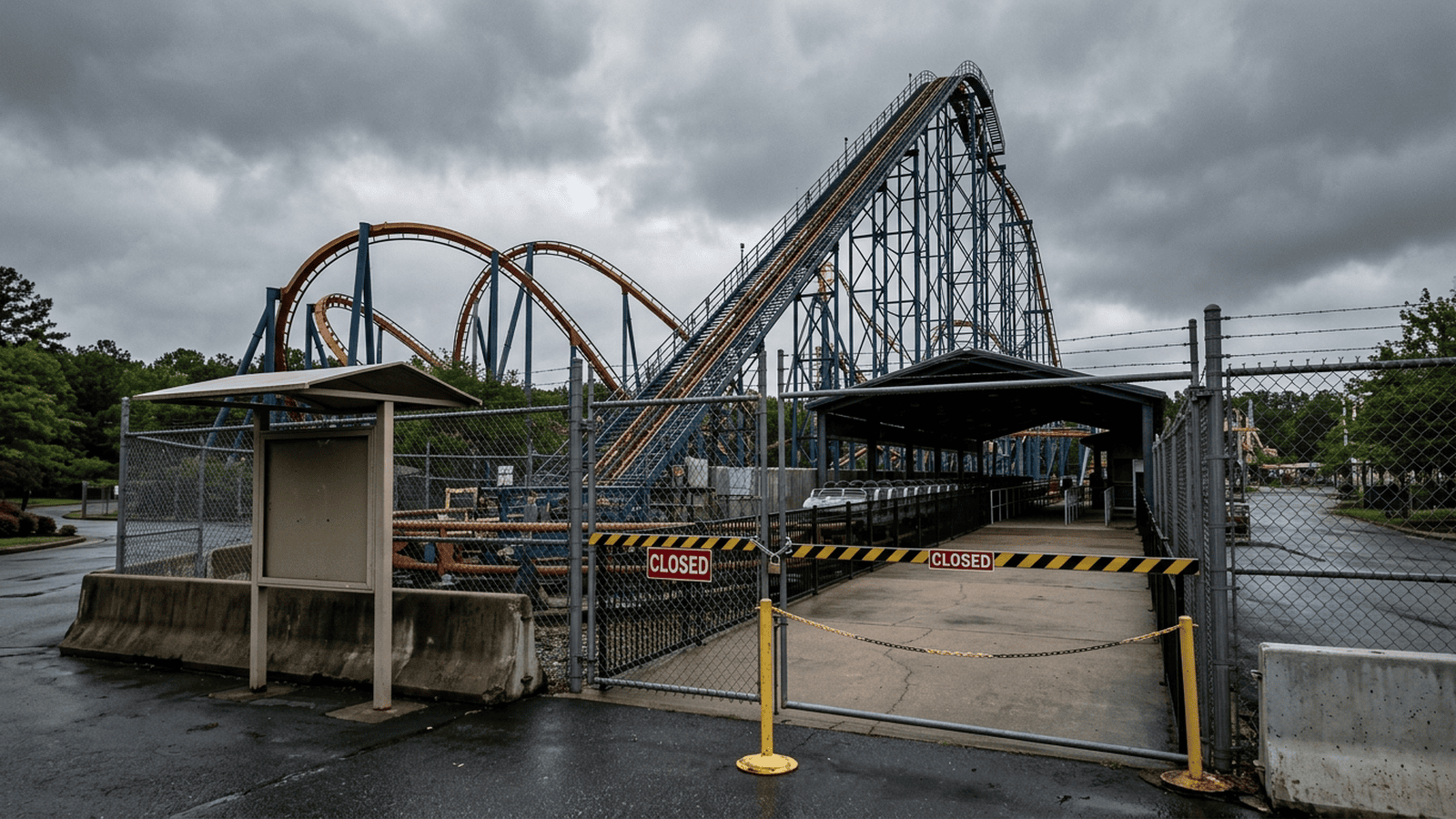 An empty roller coaster track stands closed at an amusement park.