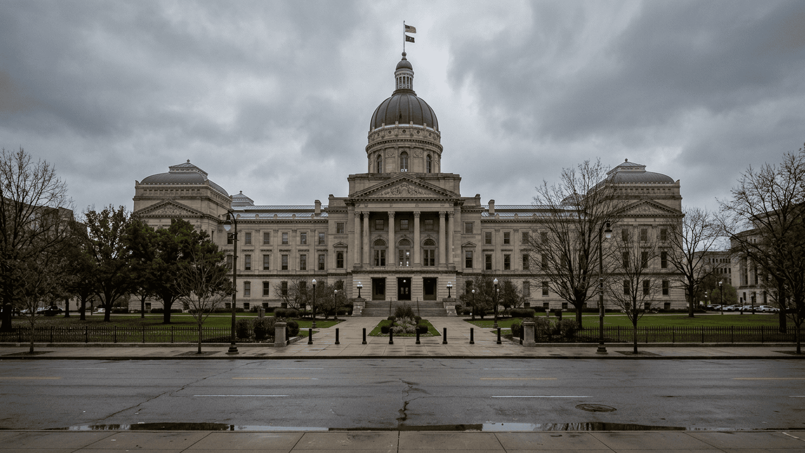 The Indiana Statehouse stands beneath an overcast sky.