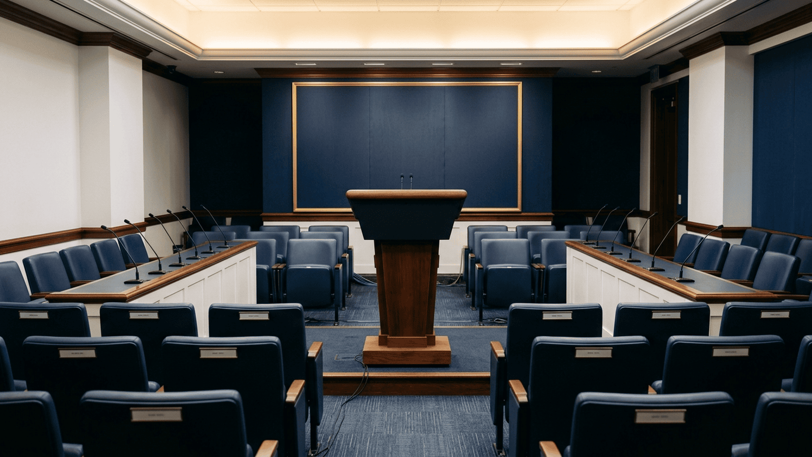 An empty White House briefing room with a lectern and microphones.