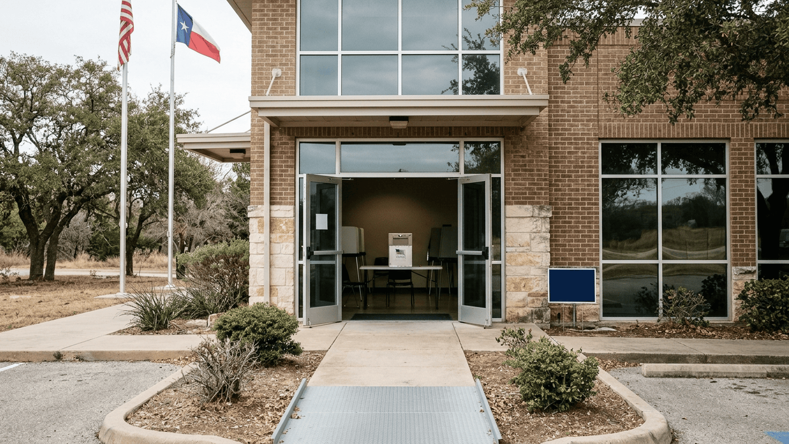 An empty Texas polling place entrance with a ballot box visible inside.