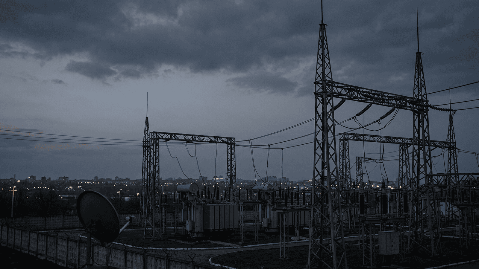 c50ea3f6feea61e6d93e82f37de0f4b257ca04b86ba28ecbbb8099e662131305 A power substation and city buildings stand in dim light after reported outages in Kyiv.