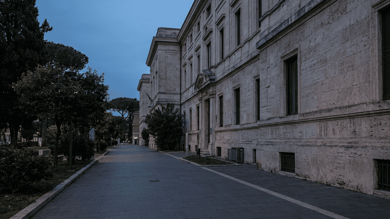 The entrance area of a hospital in Rome is shown in soft evening light.