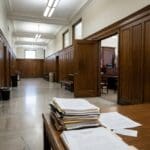 Courts Narrow Macrons’ Suit, Weigh Union Surveillance Challenge